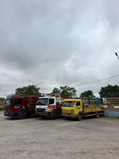 Três caminhões de entrega da Pantanal Gás estacionados no pátio