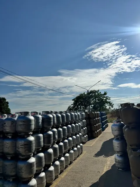 Fileiras de botijões prata organizadas no pátio da Pantanal Gás